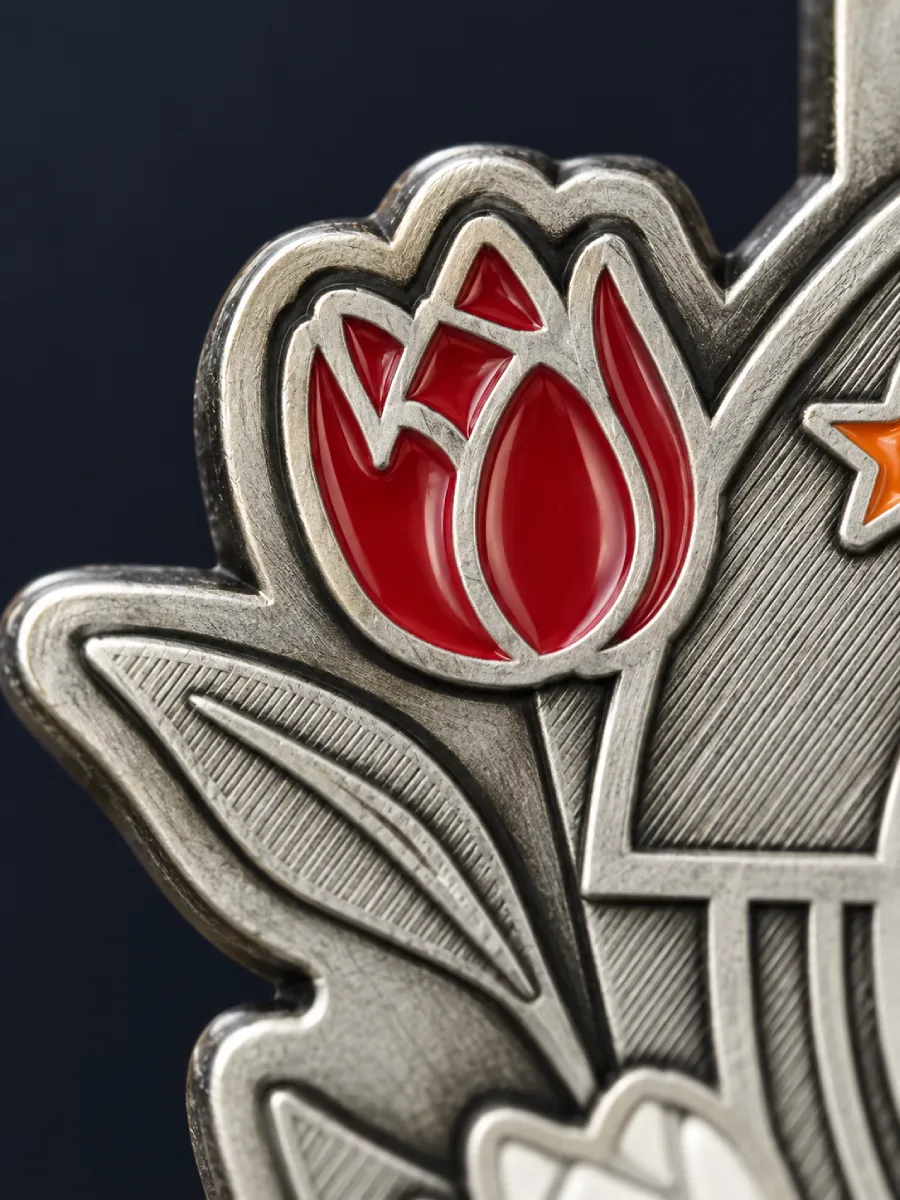 Macro of a red enamel tulip filled between raised silver metal lines