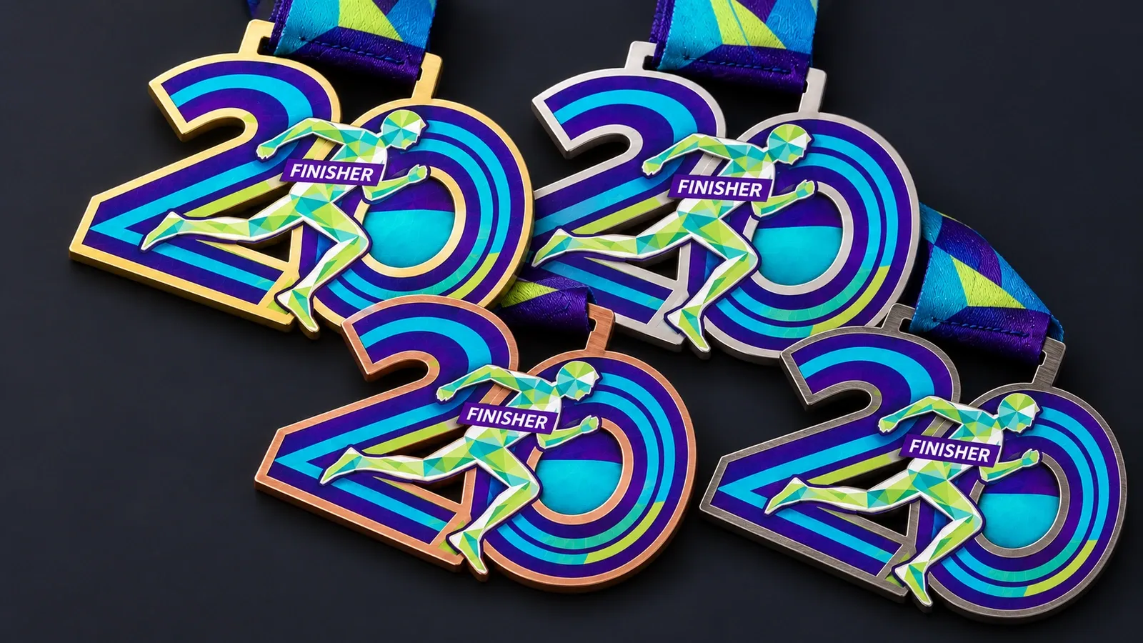 The same printed steel medal in four platings: gold, silver, bronze and black nickel