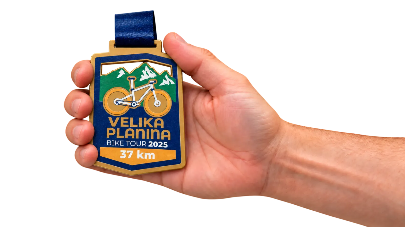 A printed steel medal held in a hand, showing its real size